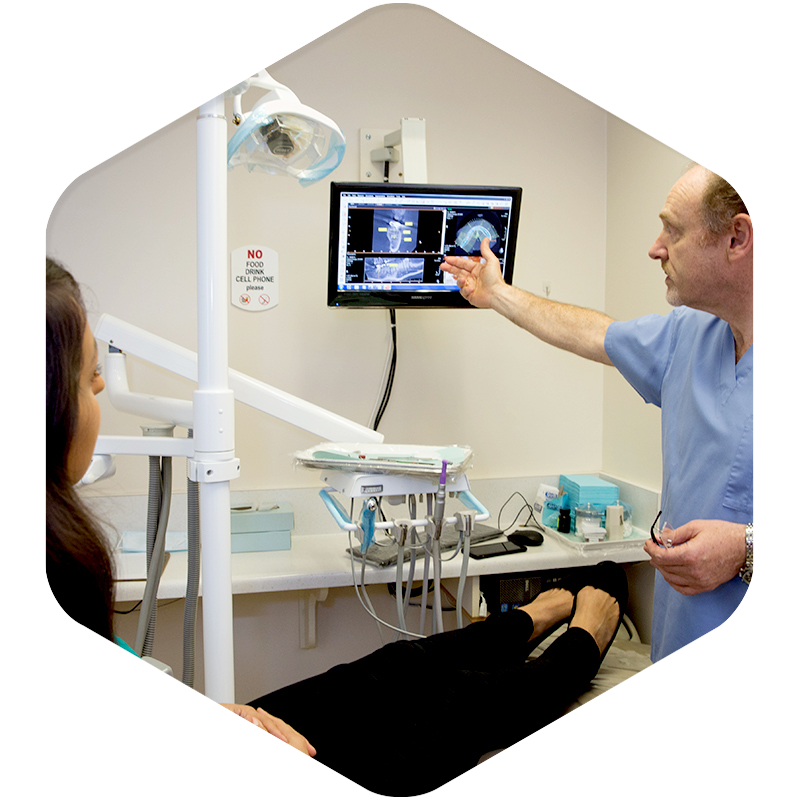 A doctor showing dental X-rays to a patient.